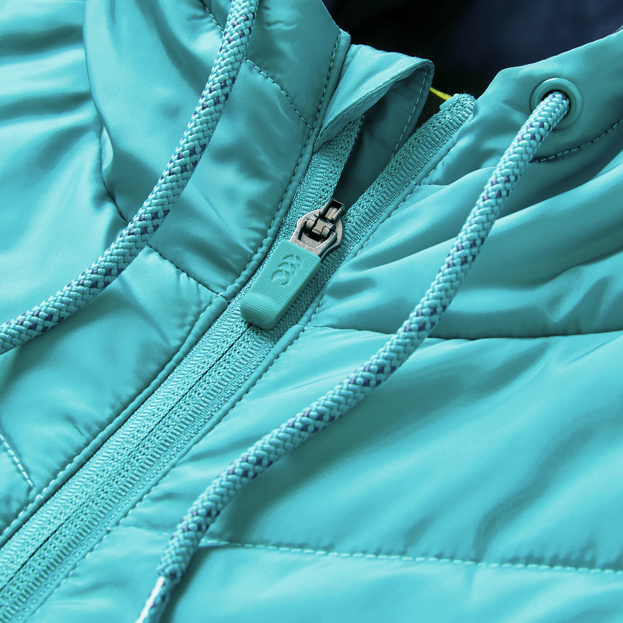 Close-up of the Ireland 26 Hybrid Padded Jacket by Canterbury in teal, highlighting the zipper, drawstrings, and stitching details—ideal as a rugby training jacket.