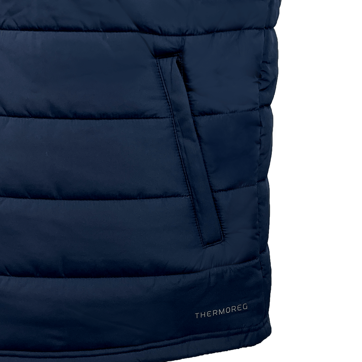 Close-up of a blue USA Shield Core Gilet by EMB Canterbury with Thermoreg insulation, showcasing a vertical zip pocket and "THERMOREG" branding near the bottom. Perfect for chilly days, it blends style and functionality effortlessly.