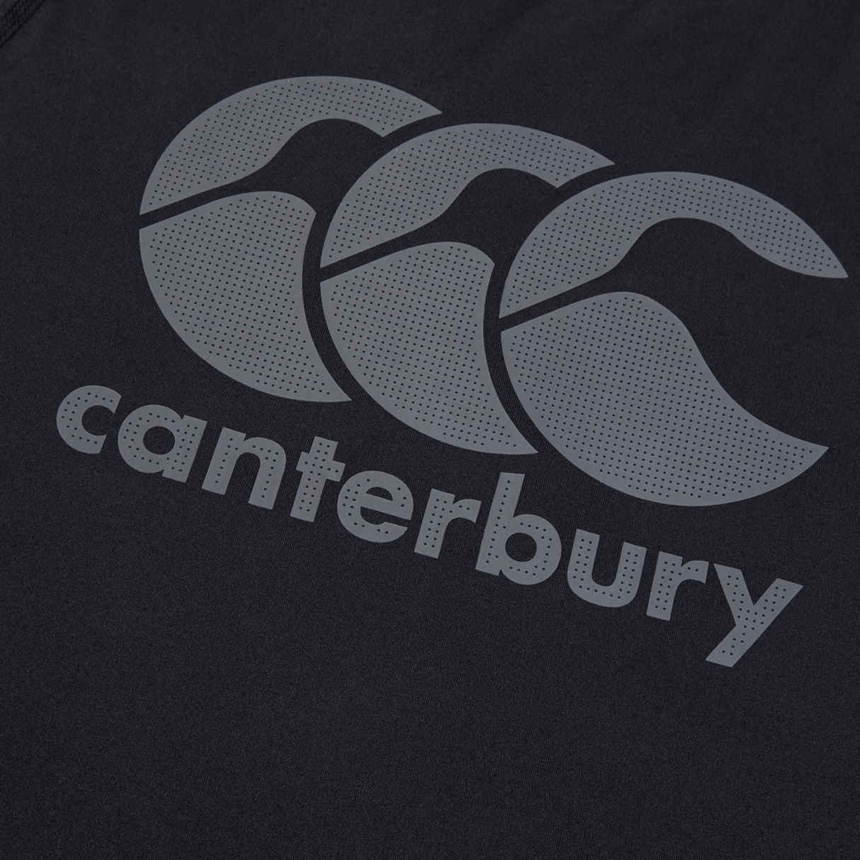 Close-up of the Canterbury Large Logo Superlight Tee, displaying the iconic Canterbury logo with three overlapping grey motifs above "canterbury" in lowercase—a lightweight, high-performance shirt ideal for rugby training.