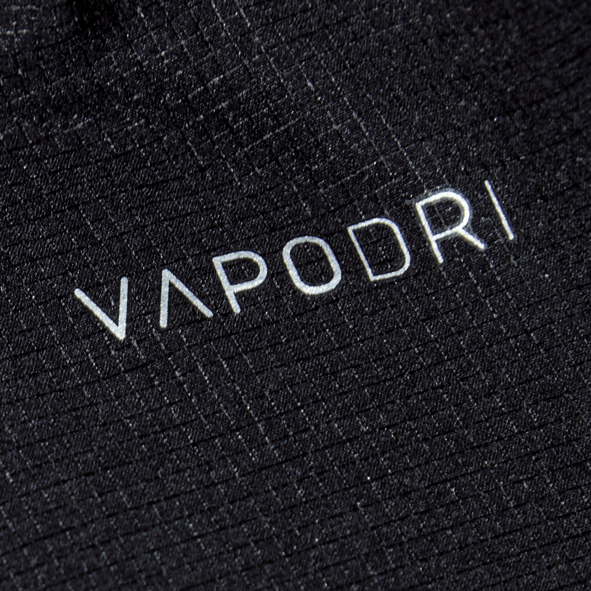 Close-up of black Vapodri fabric with "VAPODRI" printed in white, known for its sleek design and durability, as seen in Canterbury's Women's Yokohama Short.