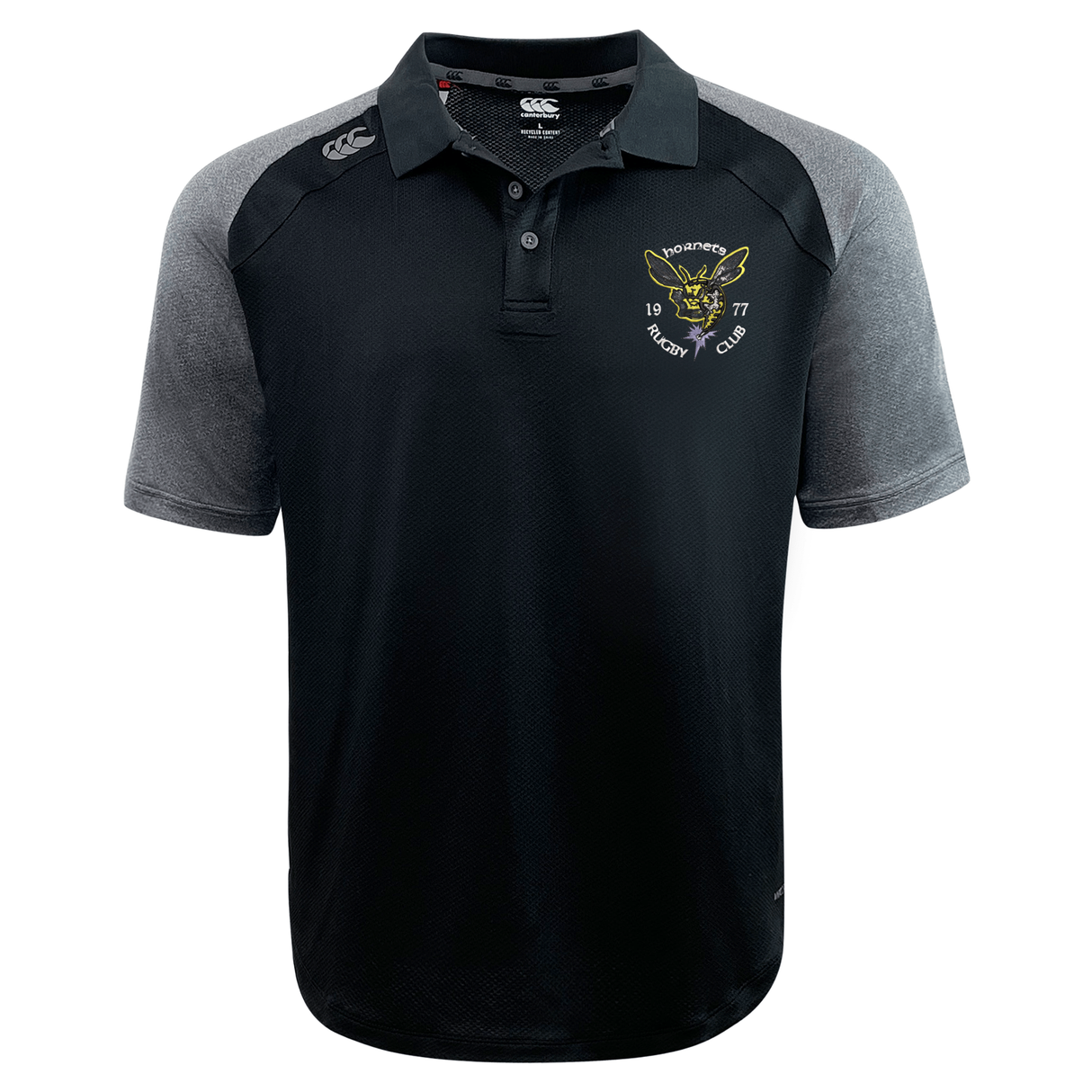The Hornets Rugby Club 1977 Elite Polo by Canterbury is a black and gray short-sleeve shirt featuring the “Hornets Rugby Club” logo and a hornet graphic on the left chest, along with a white EMB Canterbury logo on the right shoulder. Made from lightweight, durable Vapodri fabric, this polo delivers exceptional comfort and breathability both on and off the field.