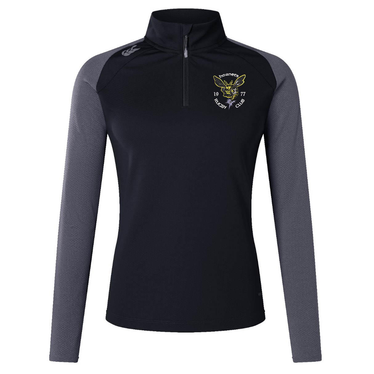 The Hornets Rugby Club 1977 Women's Elite First Layer by EMB Canterbury is a black quarter-zip long-sleeve athletic top featuring gray sleeves and a yellow embroidered “Hornets Rugby Club” logo on the left chest. Crafted with moisture-wicking VapoDri technology for enhanced comfort, this top is inspired by the Canterbury Women's Elite First Layer and is designed to keep you dry and performing your best both on and off the field.