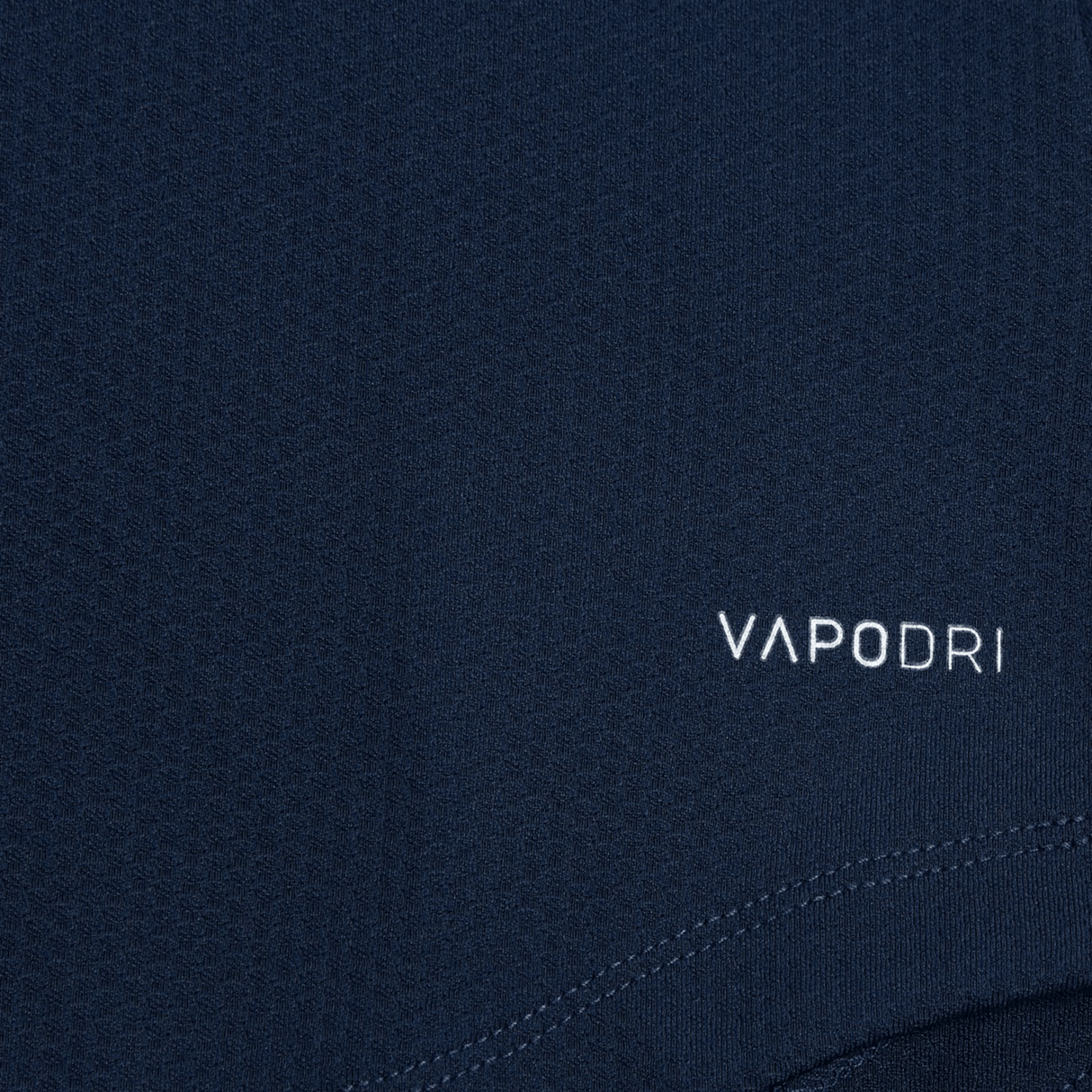 Close-up of the Women's Canterbury Elite First Layer in dark blue, featuring the "VAPODRI" logo and innovative honeycomb fabric design by Canterbury for optimal performance.