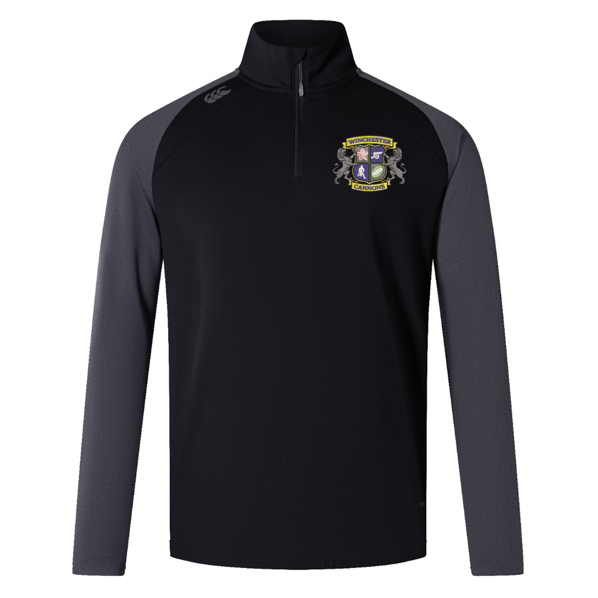 The Winchester Cannons Elite First Layer by EMB Canterbury is a black and grey long-sleeve quarter-zip rugby top with a crest on the left chest, brand logo on the right shoulder, and VapoDri tech for comfort.