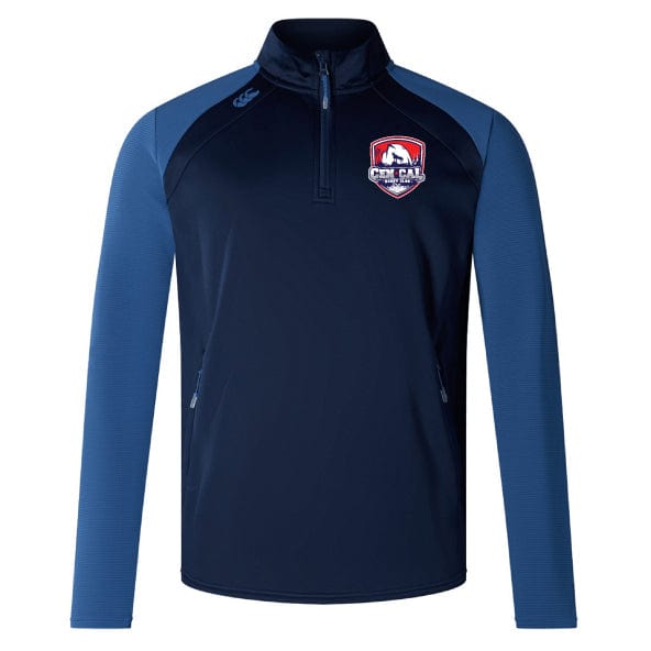 The CenCal Rugby Elite First Layer by EMB Canterbury is a navy quarter-zip top with light blue sleeves, zippered pockets, a red and white crest on the chest, and VapoDri technology for advanced moisture control.