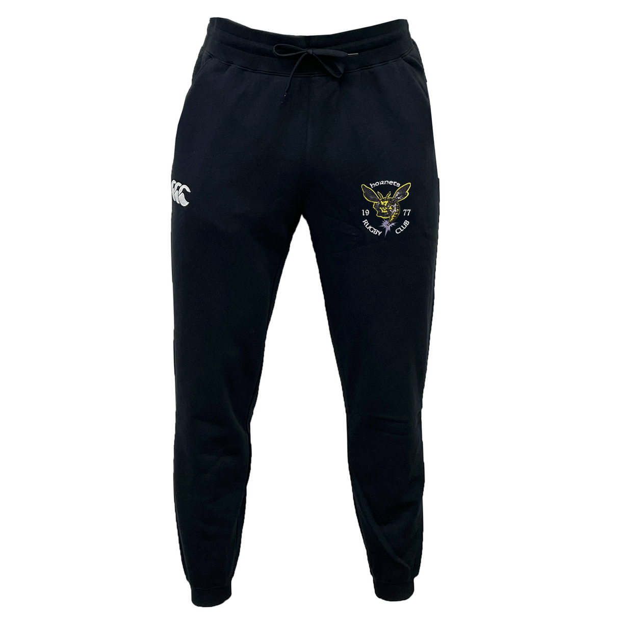 Hornets Rugby Club 1977 Leisure Sweatpants by EMB Canterbury, in black, featuring a drawstring waist, the Canterbury logo on the right thigh, and an embroidered Hornets badge with yellow and green detailing on the left thigh.