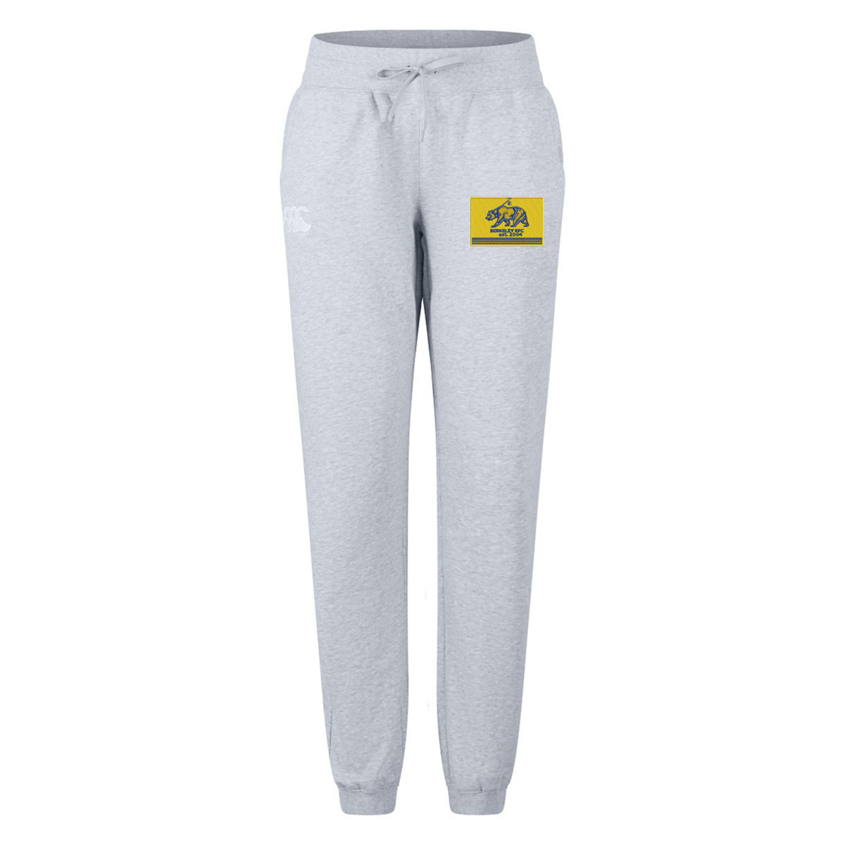 Light gray Berkeley RFC Women’s Leisure Sweatpant by Canterbury jogger-style sweatpants with a drawstring waist and a rectangular patch featuring a yellow bear logo on the left hip.