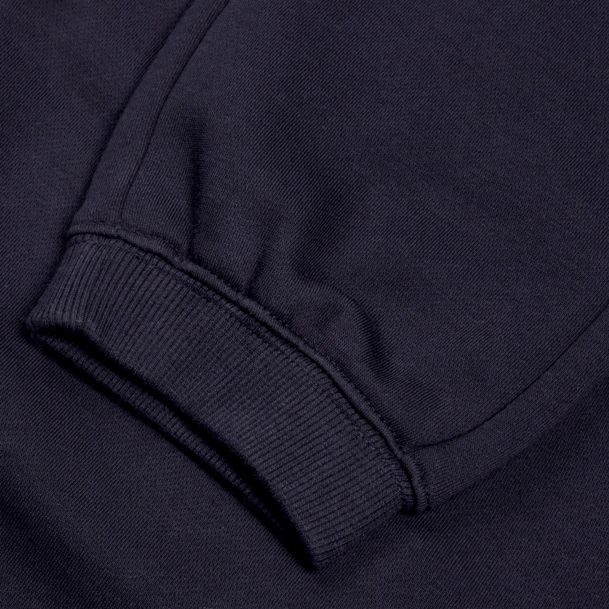 Close-up of a sleeve from Canterbury's Women's Leisure Sweatpant, featuring ribbed cuff detail in a navy blue, cotton blend fleece.