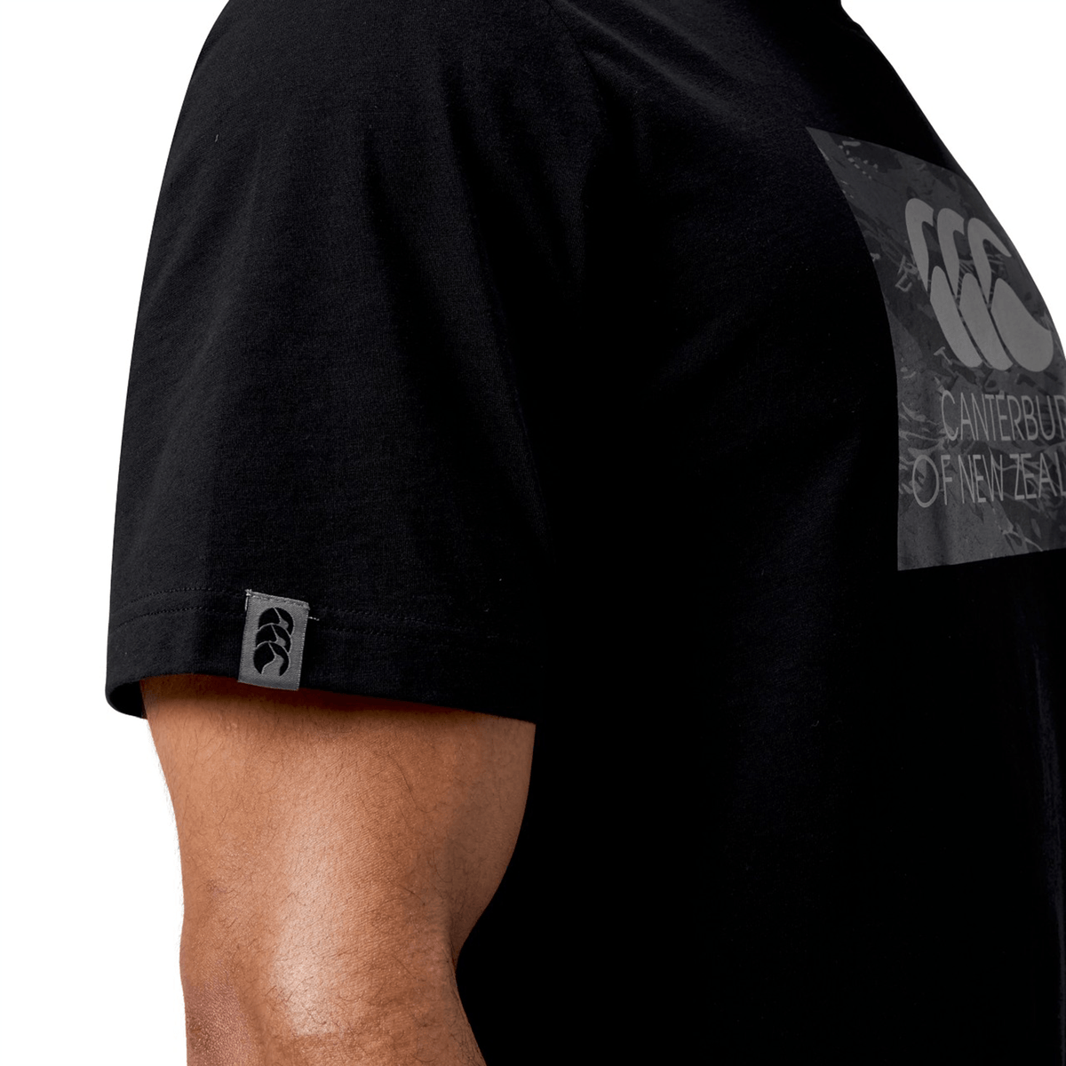 Wearing the versatile Canterbury Force T-Shirt by Canterbury, this person exudes casual style with its classic black color and signature logo. Its relaxed fit promises all-day comfort, making it ideal for any occasion.