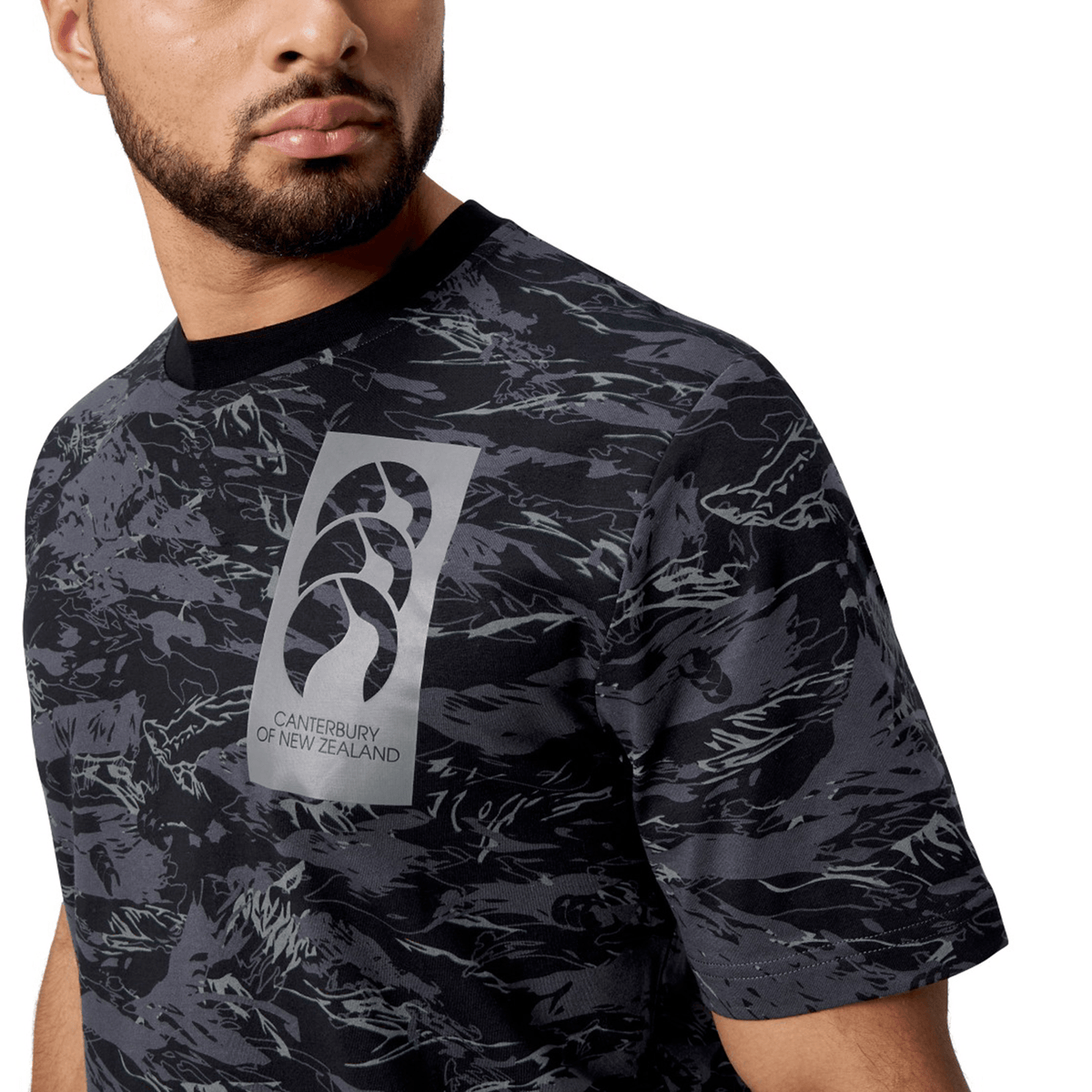 Wearing the Canterbury Force AOP T-Shirt, with a sleek black and grey pattern and a modern crew neck, you proudly showcase the iconic Canterbury of New Zealand logo on the front.