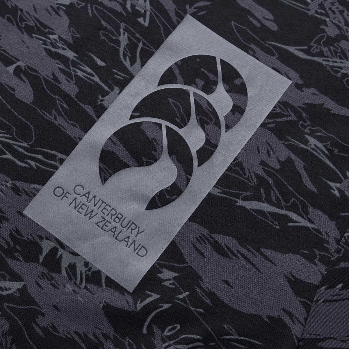 Canterbury's Force AOP T-Shirt is a modern crew neck tee with a dark camo pattern and features the distinctive "Canterbury of New Zealand" logo with three overlapping shapes.