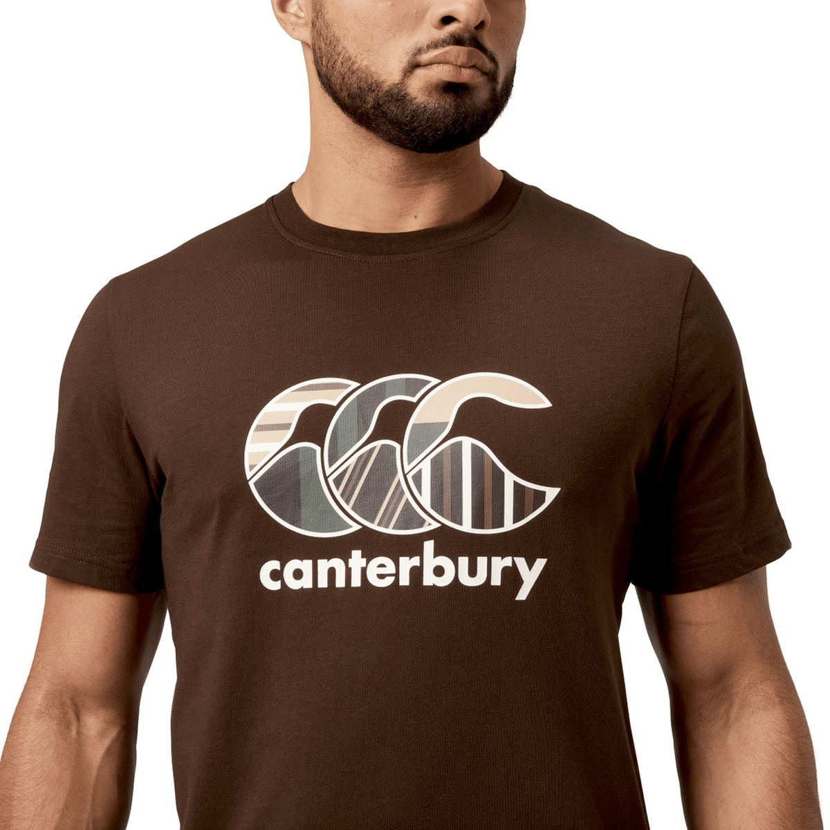 A man in a Canterbury Uglies T-Shirt showcases a stylized logo and "Canterbury" on the chest, crafted from premium cotton for comfort.