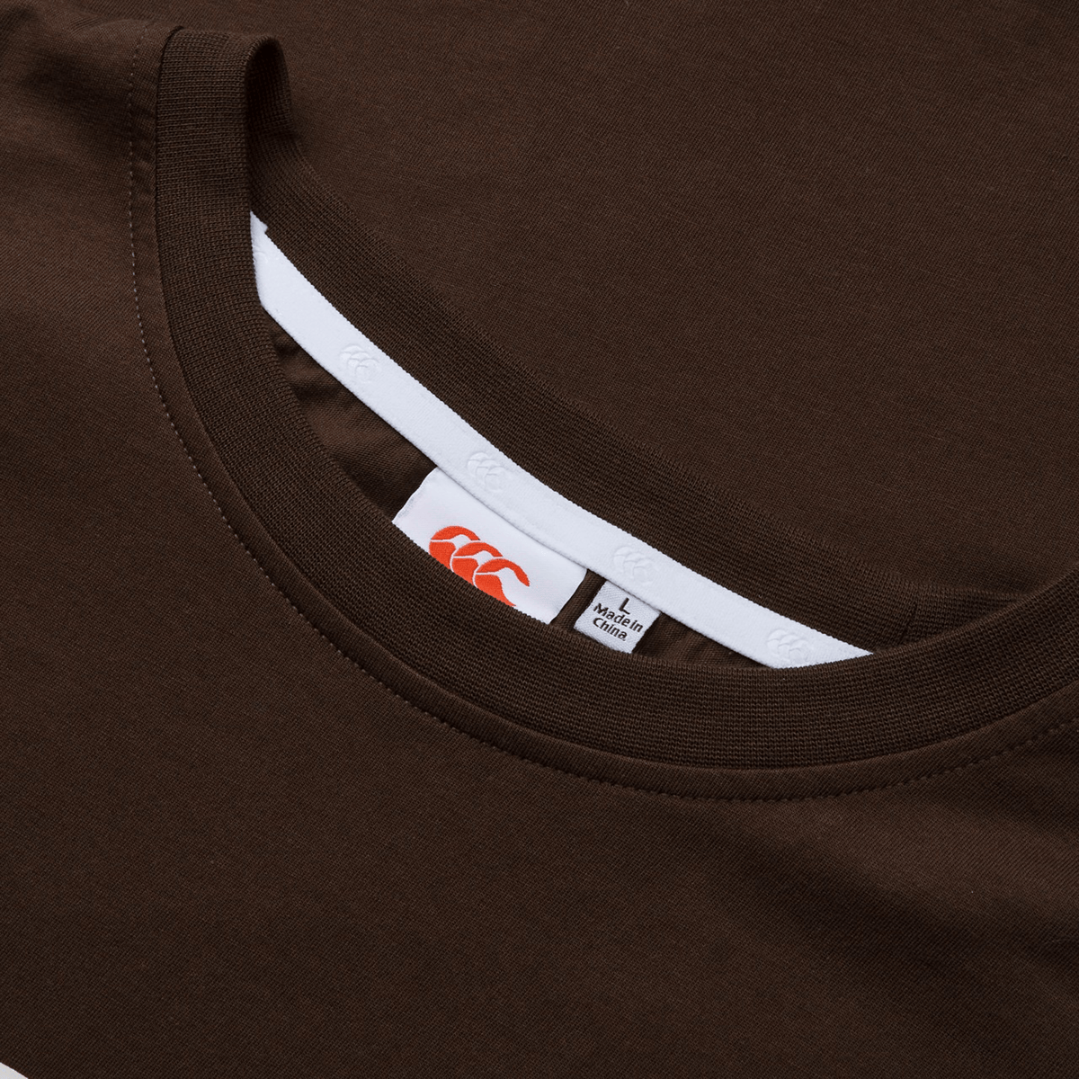 Close-up of a vibrant Canterbury Uglies T-Shirt, featuring the Canterbury brand logo and size label on the inside collar.