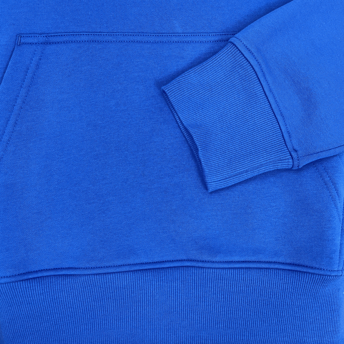 Close-up of the Canterbury Uglies Hoodie in blue, showcasing bold block colors on the sleeve and a stylized CCC logo near the front pocket.