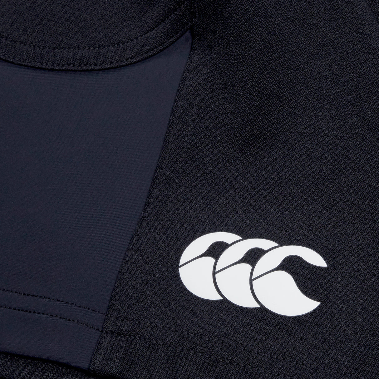 Close-up of a Women's Canterbury Advantage Short 2.0 in black, featuring a white logo of three stylized curves, crafted by Canterbury with recycled content for sustainability.