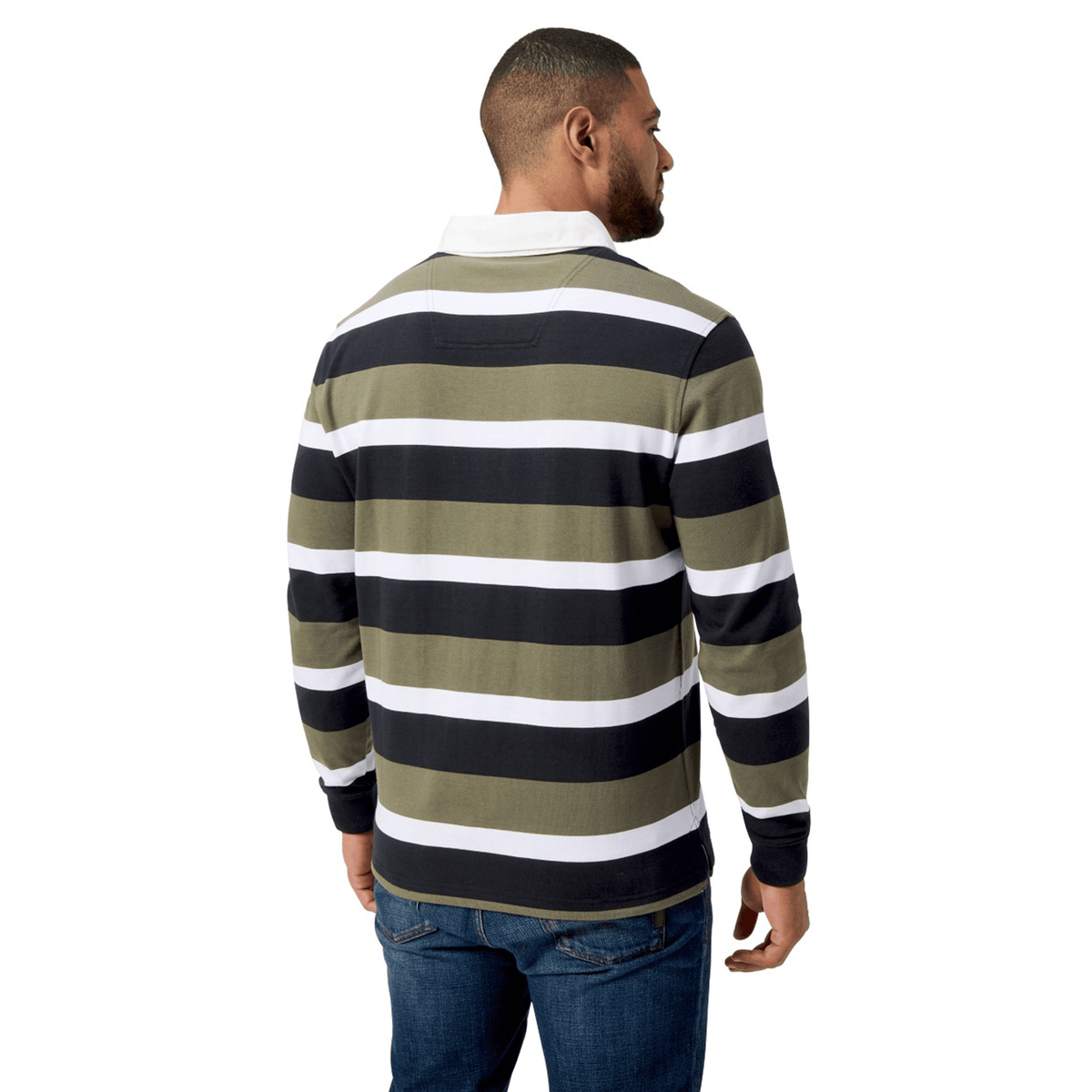 A person stands with their back to us, wearing the Canterbury Yarn Dye Long Sleeve Striped Rugby Jersey in black, white, and olive.