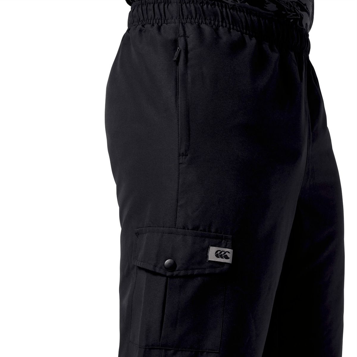 Someone is wearing black Canterbury Force Straight Leg Pants with an elastic waistband and a pocket flap showcasing a small logo.