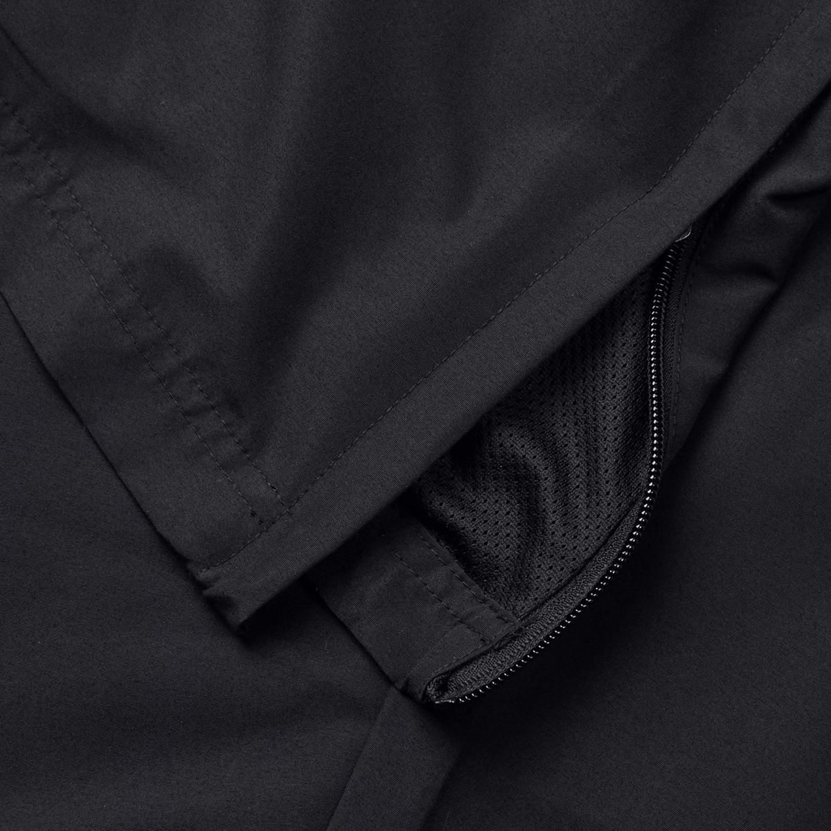 Close-up of a black activewear jacket with a partially opened zipper revealing inner mesh lining, perfect for pairing with your favorite Canterbury Force Straight Leg Pant.