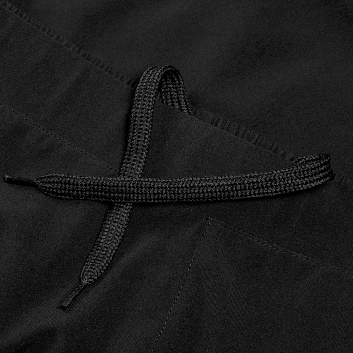 Close-up of a black drawstring tied in a loose knot on Women's Ireland 25/26 Woven Gym Short by Canterbury, made from soft black fabric.