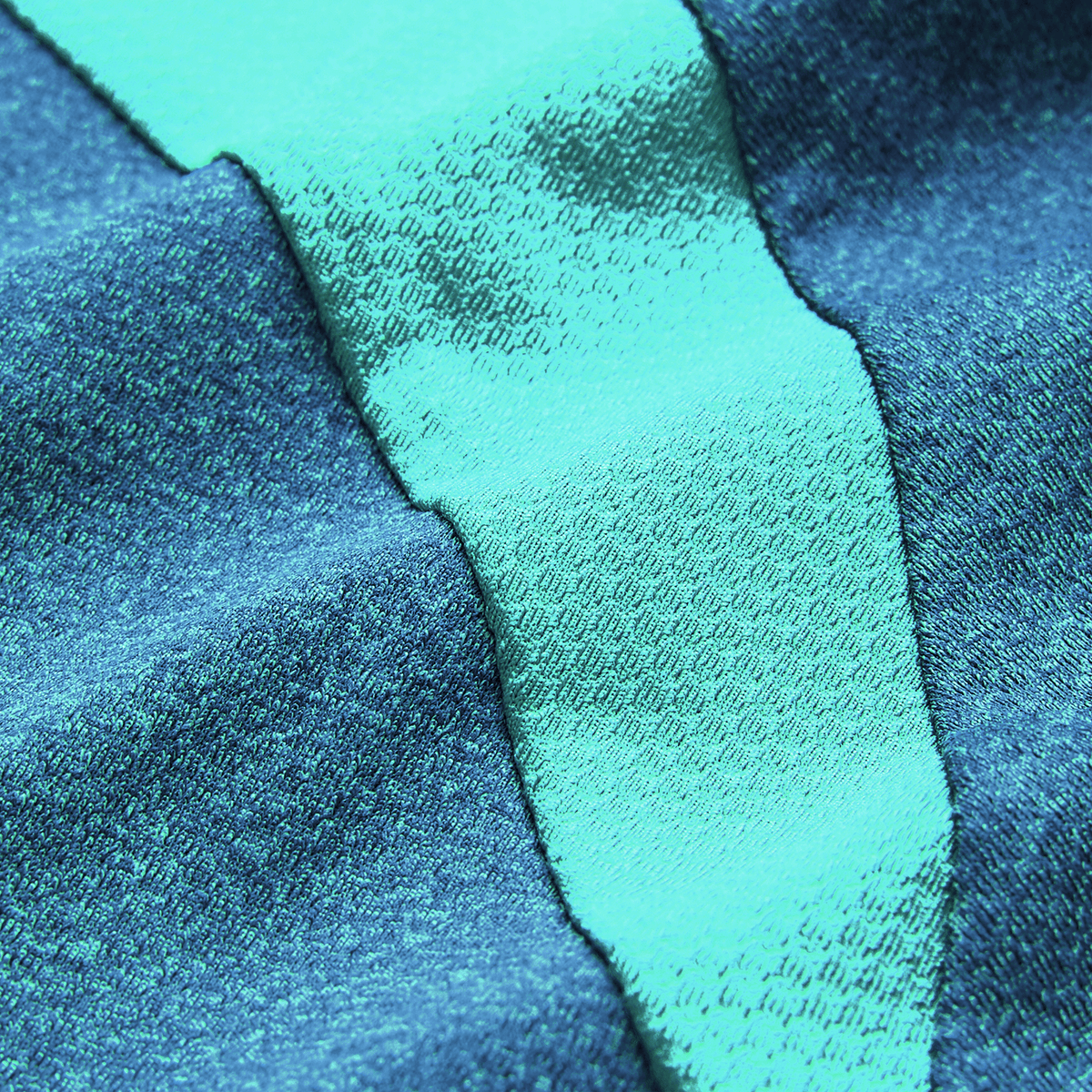 Close-up of textured fabric with alternating teal and turquoise diagonal stripes, mirroring the premium materials in the Canterbury Ireland 26/27 Summer Tour Elite Training Tee.