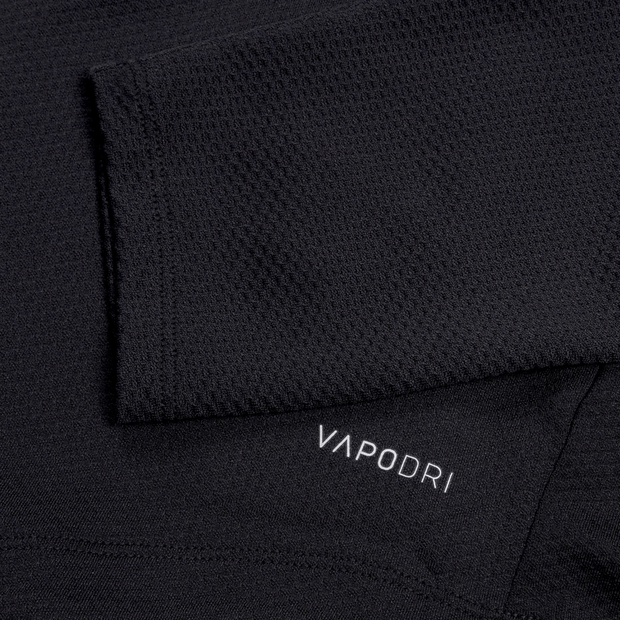 Close-up of the Ireland 25 Elite First Layer by Canterbury, a black textured training top featuring VapoDri technology and "VAPODRI" printed in white.