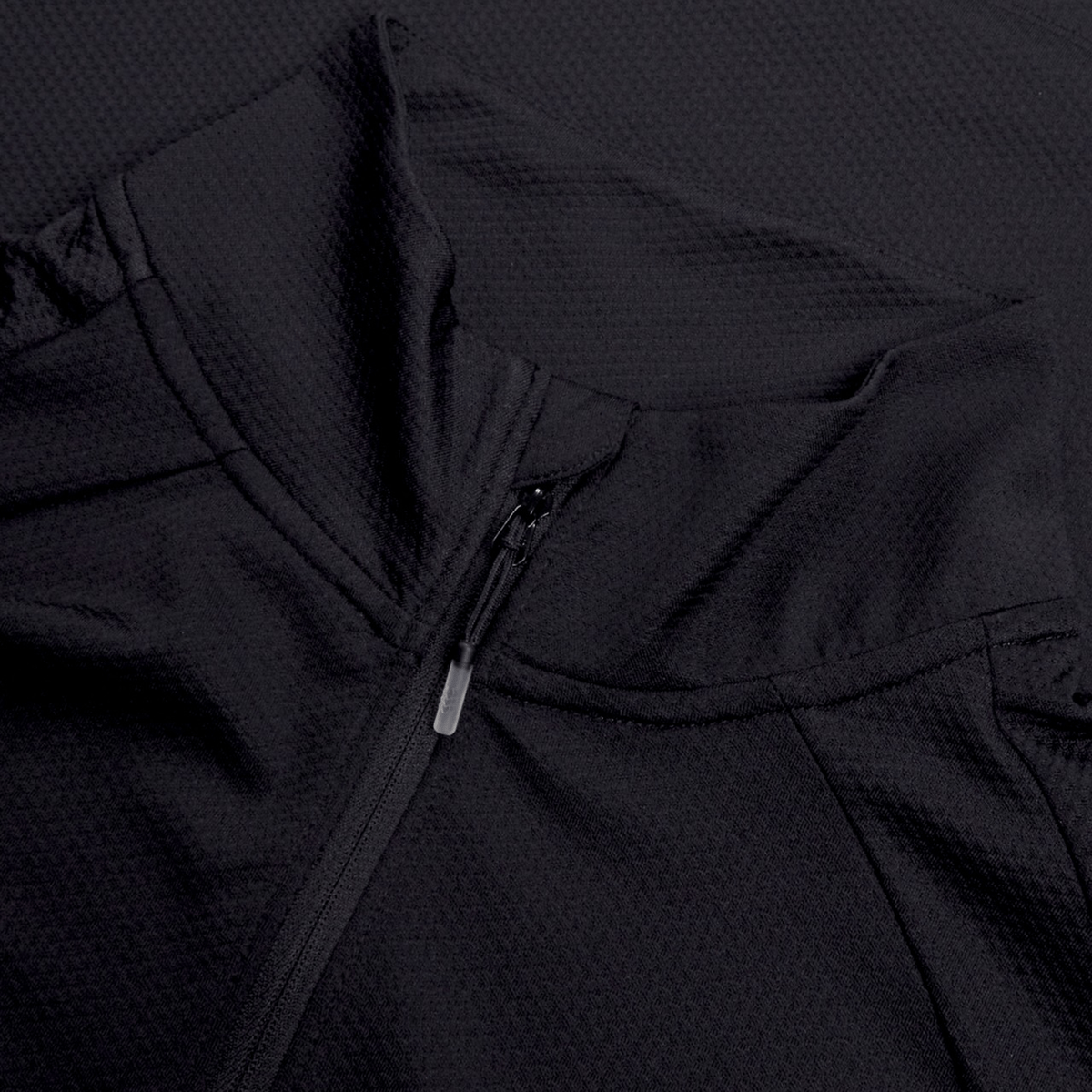 Close-up of the black Ireland 25 Elite First Layer by Canterbury, a textured fabric jacket with a front zipper and overlapping collar detail, inspired by Ireland’s elite training gear.