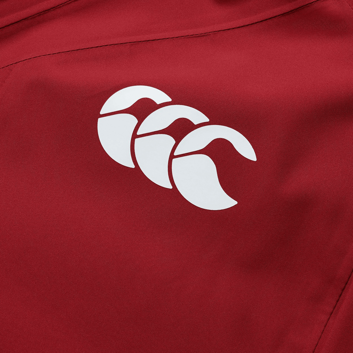 British & Irish Lions 2025 waterproof jacket by Canterbury, made from red polyester fabric and adorned with a white Canterbury logo featuring three stylized overlapping shapes that evoke the iconic British & Irish Lions design.