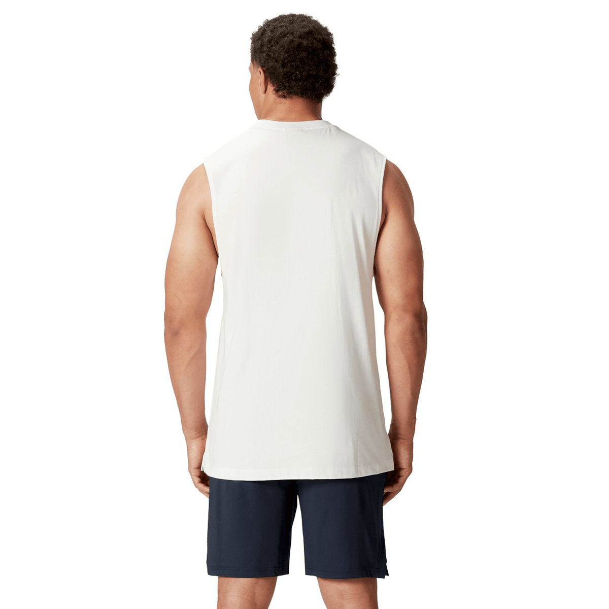 A person wearing a white Canterbury British & Irish Lions 25 Cotton Muscle Tank and black shorts is standing with their back facing the camera.