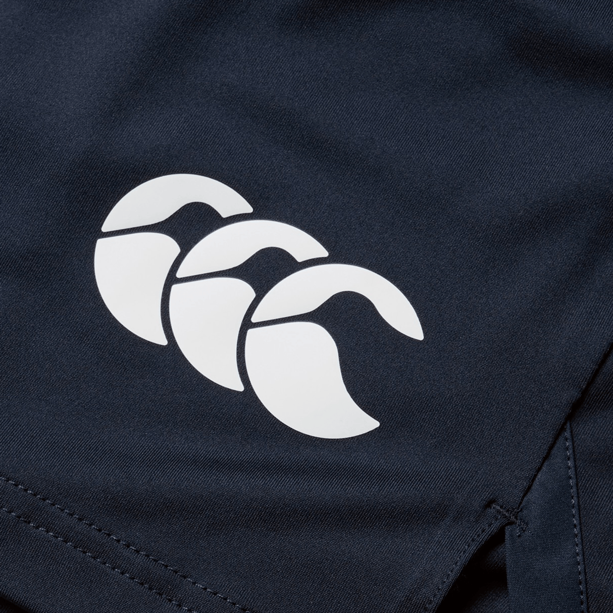 Close-up of a British & Irish Lions 2025 Training Short by Canterbury in dark blue fabric, featuring the distinctive white triple arc logo.