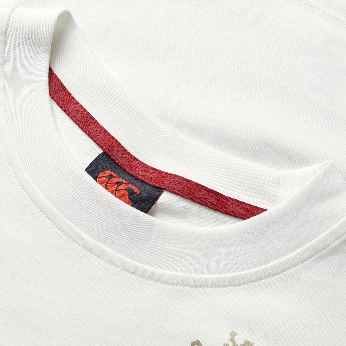 A close-up of the British & Irish Lions 2025 Women's Cotton Jersey Tee by Canterbury, a white T-shirt made from organic cotton with a red interior neckline and a visible logo tag, ideal for the discerning rugby supporter.