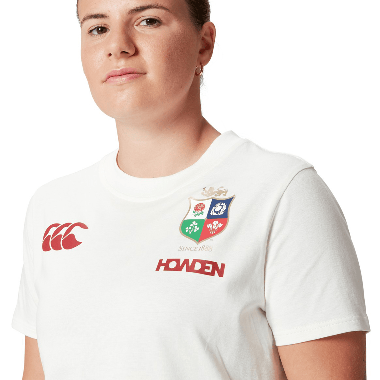 A dedicated rugby fan proudly wears the Women's British & Irish Lions 25 Cotton Jersey Tee by Canterbury, featuring the Canterbury brand and Howden logos to display their loyalty to the British & Irish Lions.