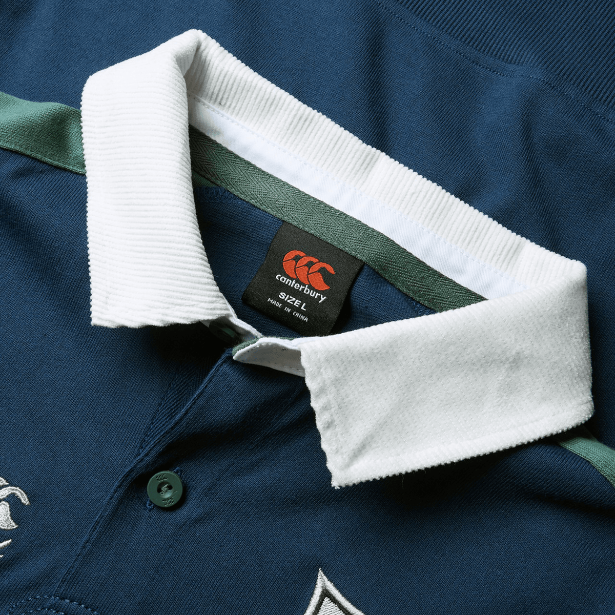 The British & Irish Lions 2025 Heritage Jersey by Canterbury is a blue rugby shirt with a white collar and green accents, complete with a buttoned neckline and an embroidered logo. This jersey honors the classic style of the British & Irish Lions, merging timeless tradition with a modern twist.