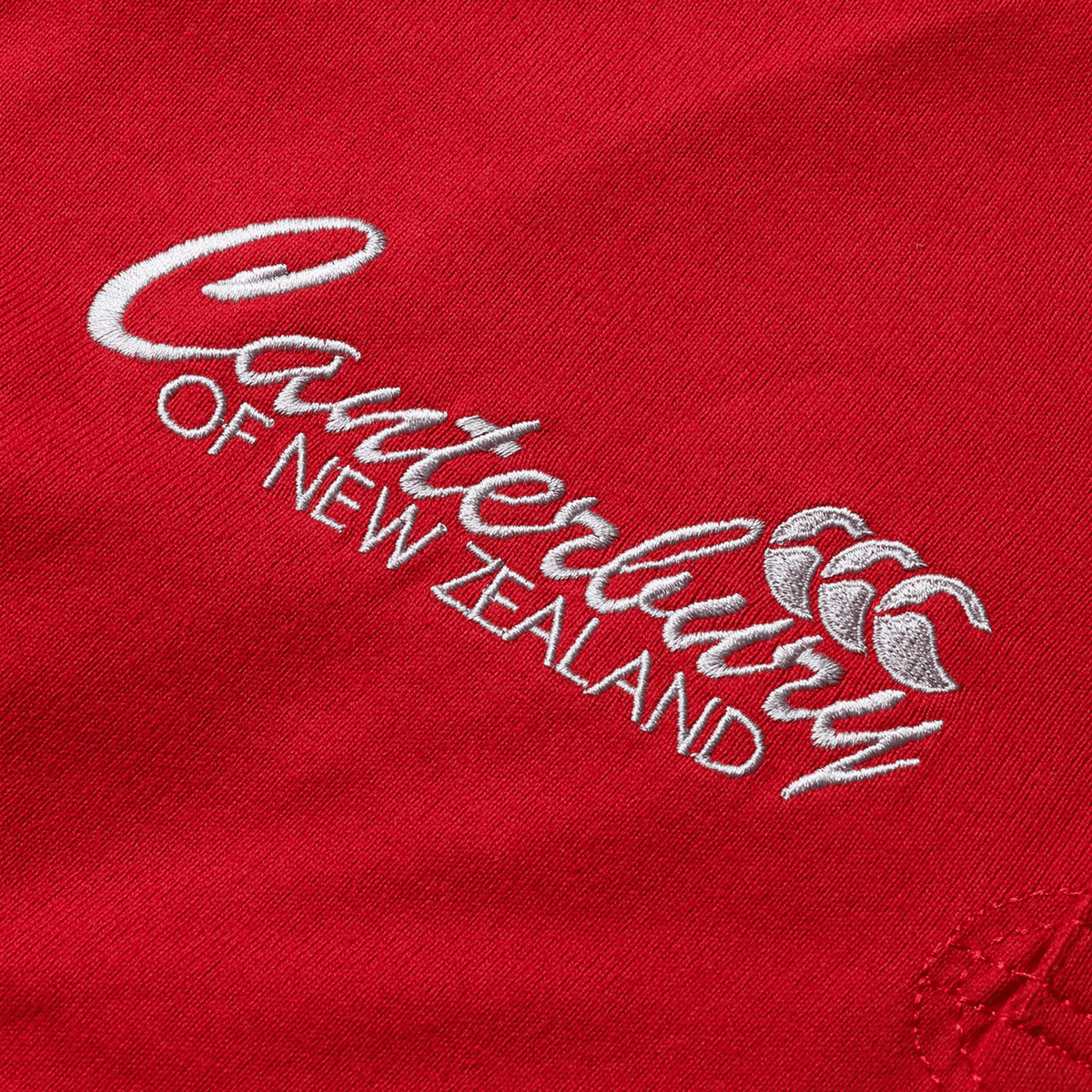 The British & Irish Lions 2025 Heritage Jersey by Canterbury highlights red fabric with the distinguished white embroidered logo of Canterbury, showcasing their signature three overlapping C's design.