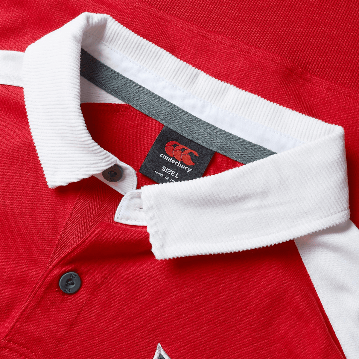 The British & Irish Lions 2025 Heritage Jersey by Canterbury is a red collared shirt with white trim, featuring the iconic Canterbury logo tag inside and a size label indicating 3XL. This timeless piece captures the spirit of a Heritage Jersey, making it ideal for fans of the British & Irish Lions.