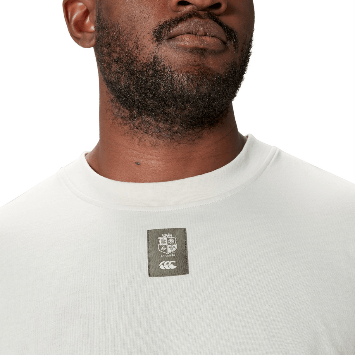 Man wearing the British & Irish Lions 25 Outback Long Sleeve Tee by Canterbury, showcasing a Canterbury logo patch with the British & Irish Lions crest on the chest.