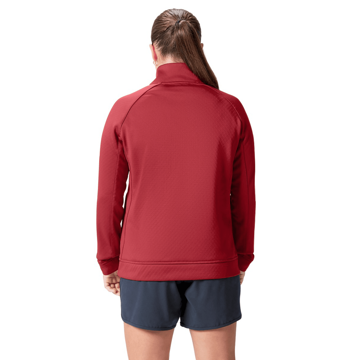 A woman with brown hair tied into a ponytail, dressed in the Women's British & Irish Lions 2025 1/4 Zip Fleece by Canterbury in red, and navy shorts, is depicted from the back.