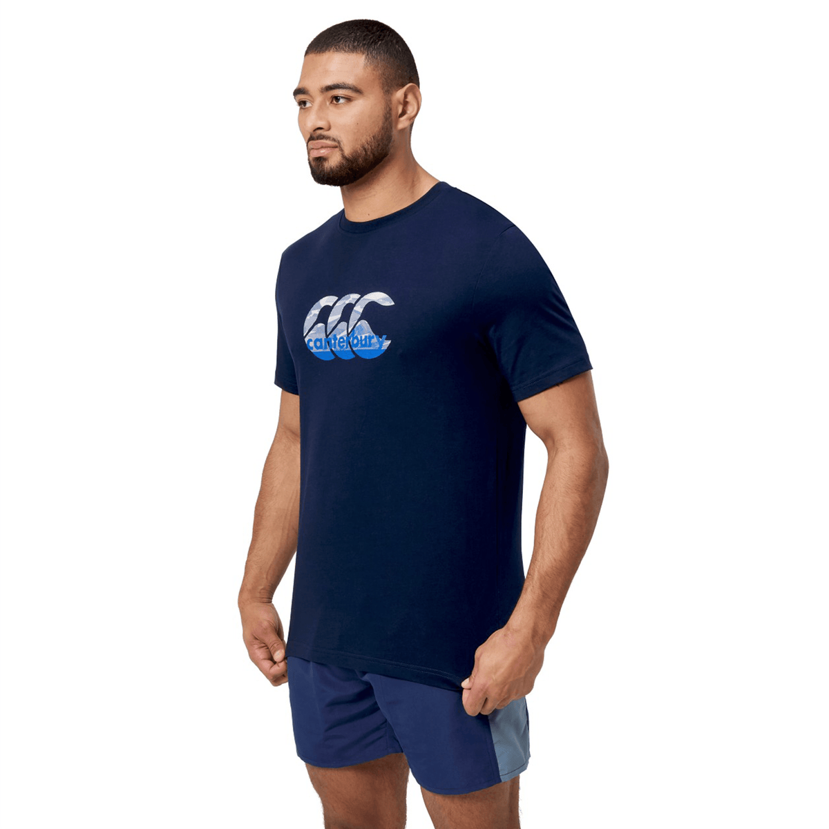 Man wearing a Canterbury Fundamental T-Shirt with CCC logo in navy blue, paired with matching navy shorts.