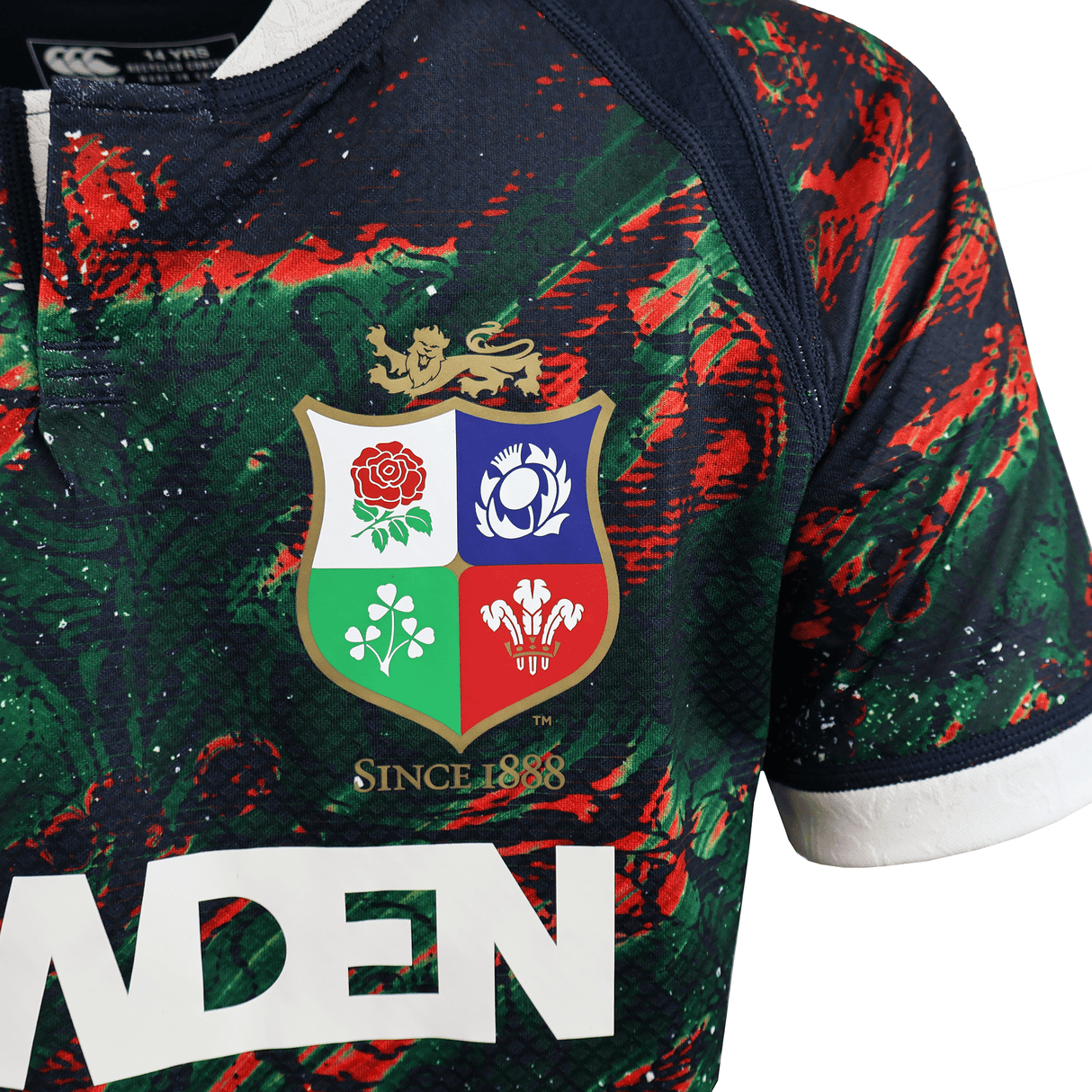 The Youth British & Irish Lions 2025 Warm Up Jersey by Canterbury features the iconic emblem with a vibrant red floral and green clover design. Made from moisture-wicking fabric, it ensures comfort for all wearers.