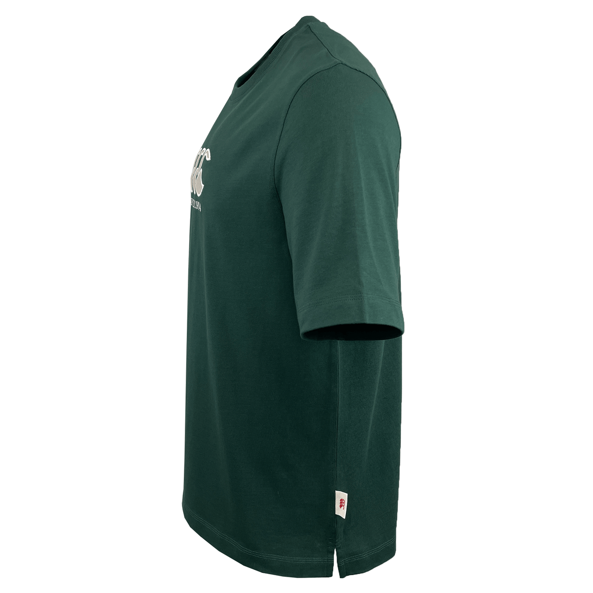 Side view of the Canterbury Heritage CCC T-Shirt in dark green, showcasing a small chest logo and hem tag. Made by Canterbury from organic cotton.