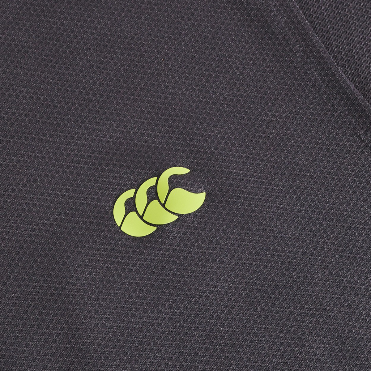 Close-up of the black Tempo+ Training Tank by Canterbury, made from moisture-wicking fabric with a small yellow-green Canterbury logo—ideal for athletic rugby training.