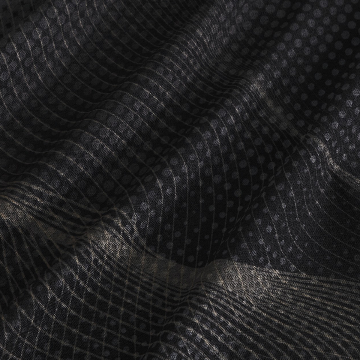 Close-up of black, moisture-wicking fabric with a grid and dot pattern, showing soft folds and subtle reflections—perfect for the Canterbury Tempo+ Singlet.