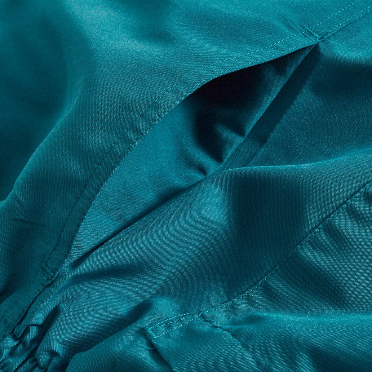 Close-up of Canterbury’s Uglies Logo Tactic Shorts in teal satin, featuring a side pocket and gathered seam detail inspired by classic rugby styles.
