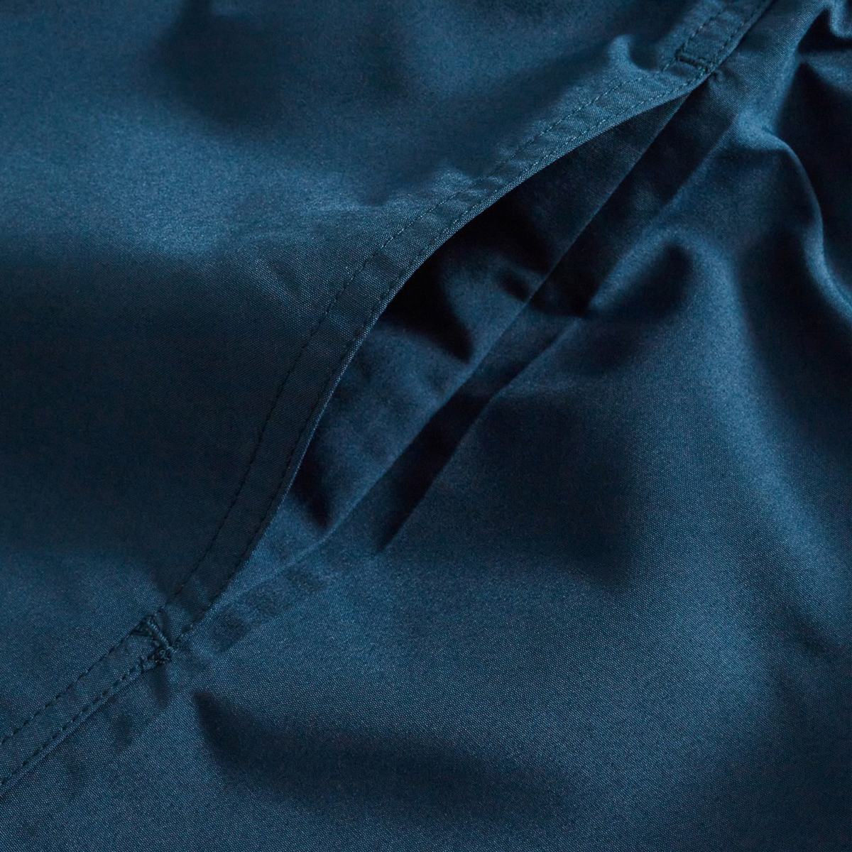 A close-up of blue fabric showcases the quality and detail in Canterbury's Uglies Logo Tactic Shorts.
