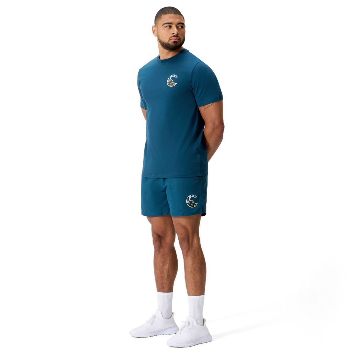 A man in a blue shirt and Canterbury Uglies Logo Tactic Shorts.