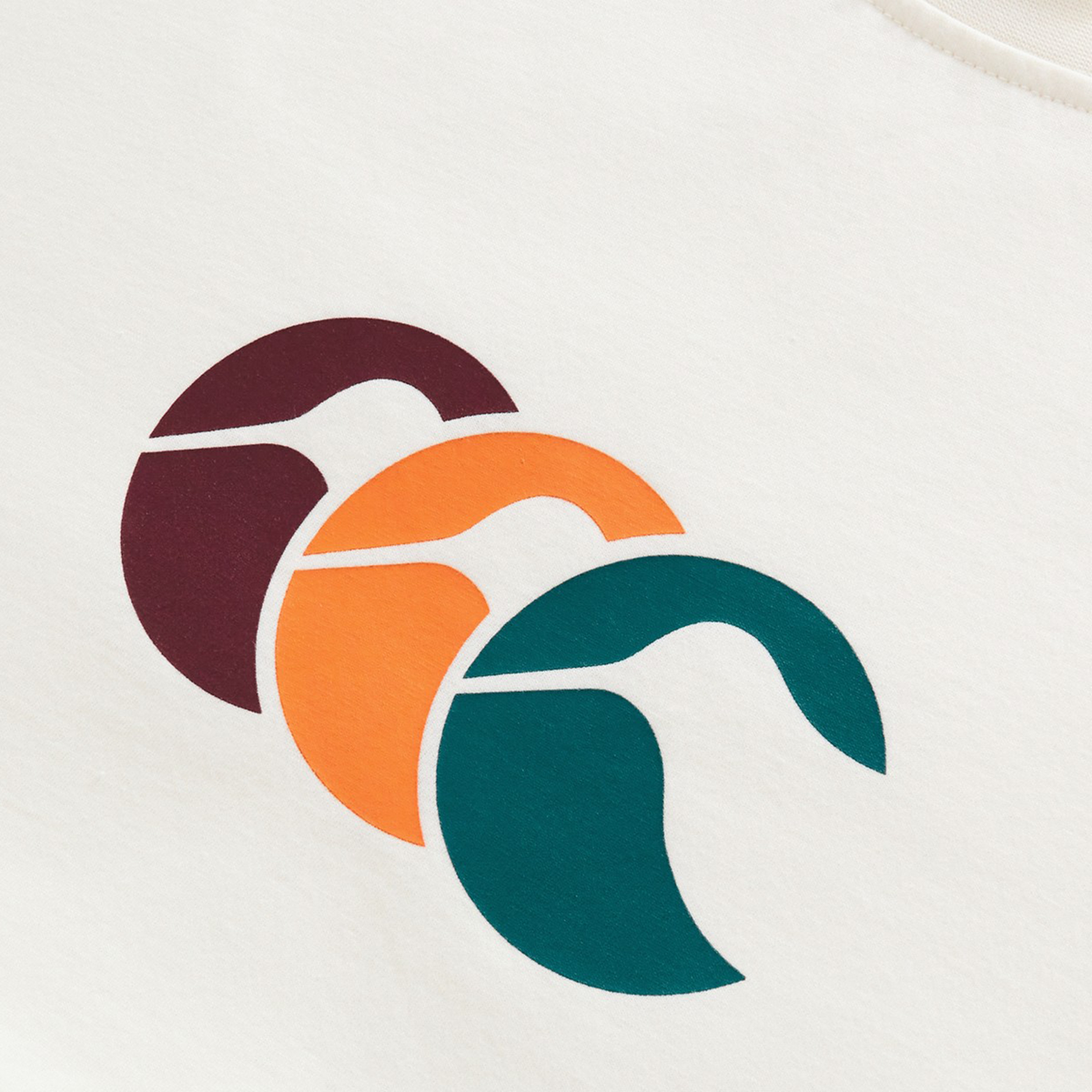 The Fundamentals CCC Logo T-Shirt by Canterbury features three overlapping abstract shapes in burgundy, orange, and teal on a white fabric background, reflecting classic Canterbury design.