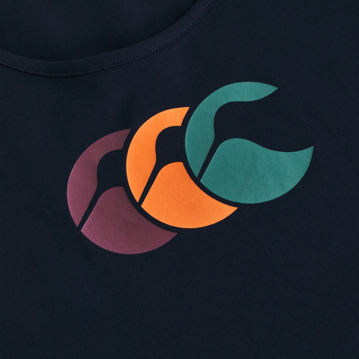 The Canterbury Fundamentals CCC Logo Tank (H225) features navy blue fabric with overlapping purple, orange, and green crescents—ideal for fans of bold, sporty design.