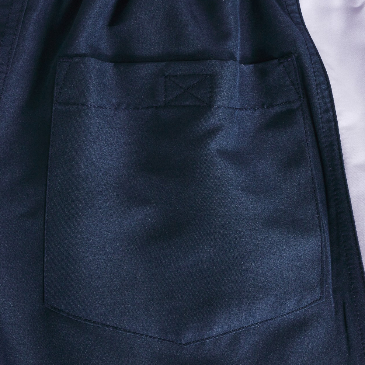 Close-up of a dark blue fabric pocket with visible stitching on the Women's Fundamentals 5" Panel Tactic Shorts by Canterbury.
