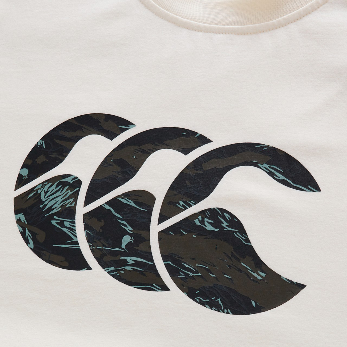 A close-up of the Force CCC T-Shirt by Canterbury, an athletic cotton-blend rugby tee featuring three overlapping wave shapes in a black and teal marbled design.