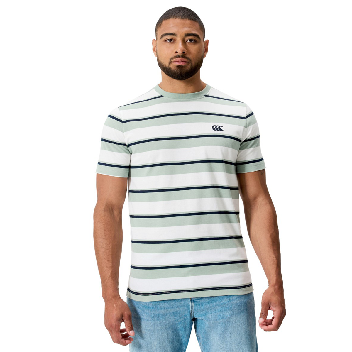 A man stands facing forward, wearing the Fundamental Yarn Dye Stripe T-Shirt by Canterbury with rugby-inspired black stripes and light blue jeans against a plain white background.