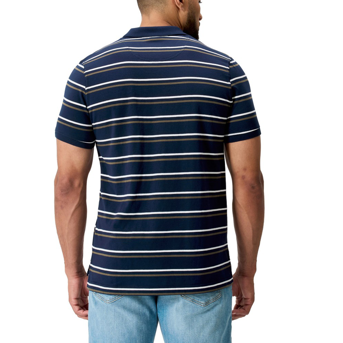 A man is shown from the back wearing the Canterbury Fundamental Yarn Dye Stripe Polo in navy with white and light gray stripes, paired with light blue jeans.